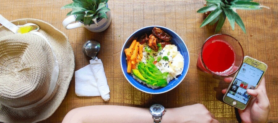 person taking photo of food salad bowl person taking photo of food salad bowl